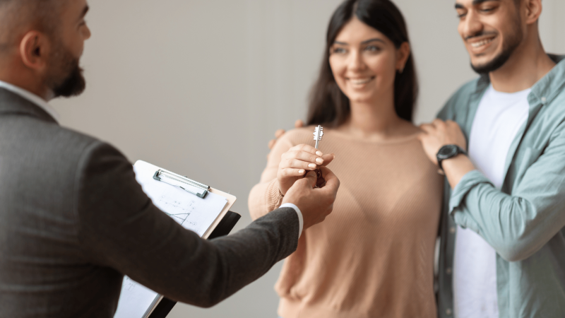 Agent handing the key to Wife and Husband, Stress-Free Property Investment