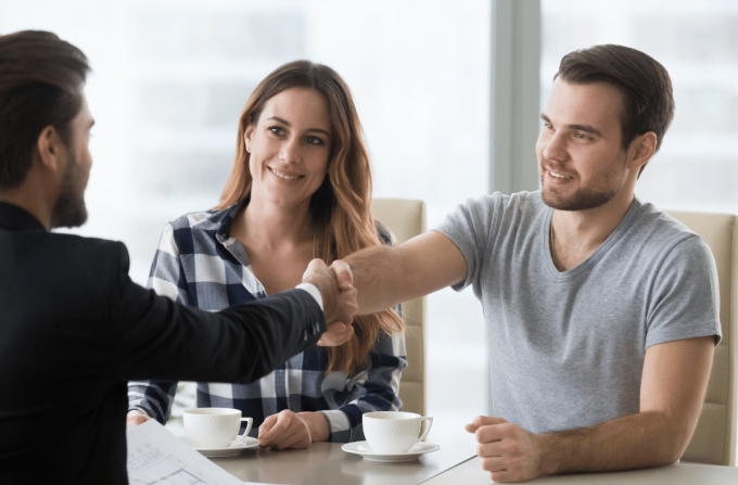 Home Buyers Handshaking with an Agent